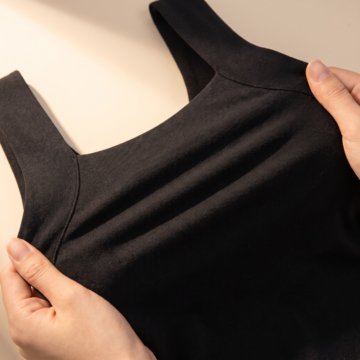 Hands stretching the black tank fabric