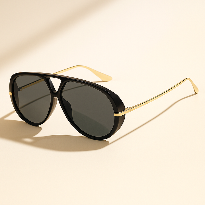 Black aviator sunglasses with gold frames on a beige background