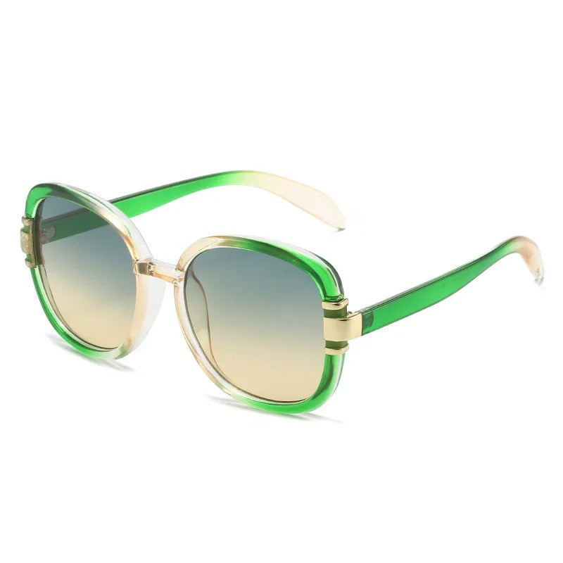 Sunglasses with green and gold gradient frame on a white background