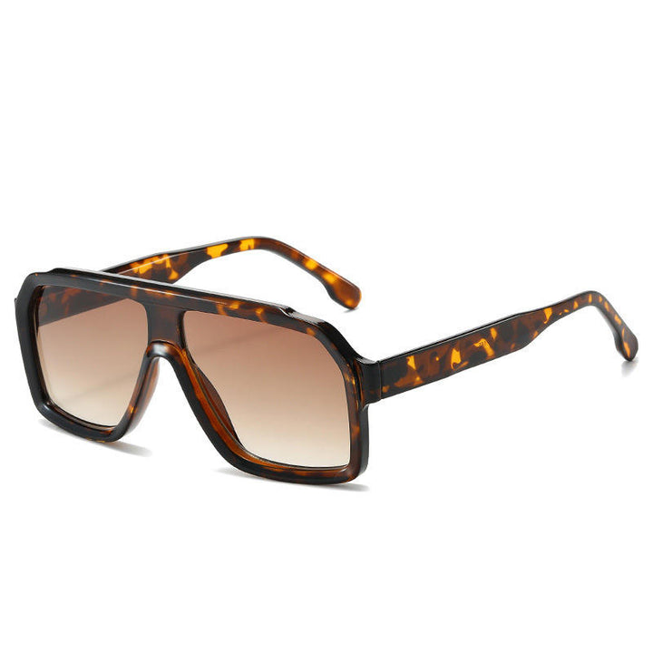 Sunglasses with tortoiseshell frame and brown gradient lenses on a white background