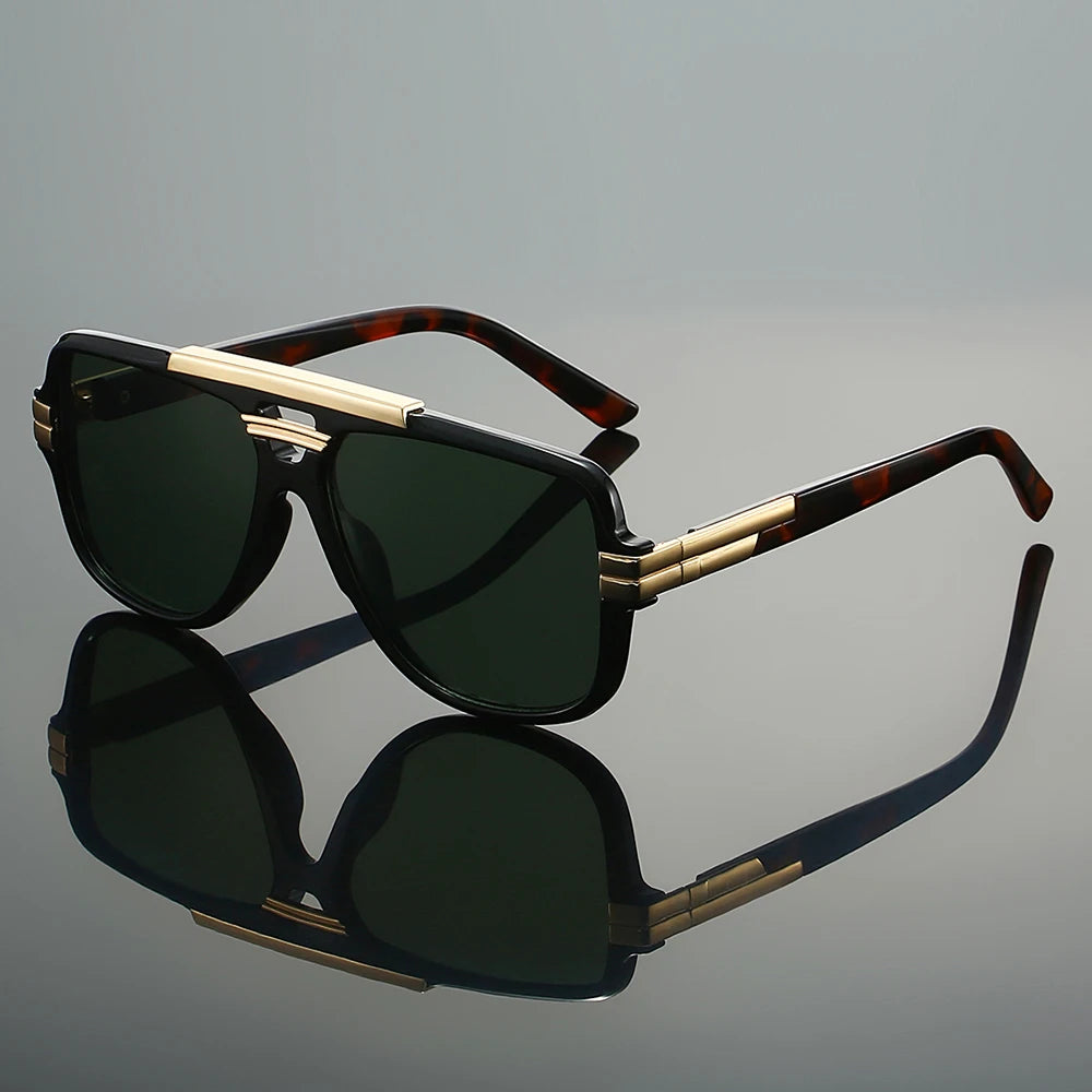 Sunglasses with gold accents on a reflective gray surface