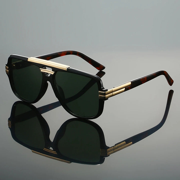 Sunglasses with gold accents on a reflective gray surface